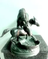 Bronze sculpture depicting a mare with her foal
