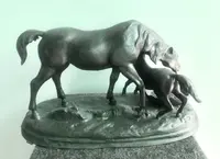 Bronze sculpture depicting a mare with her foal