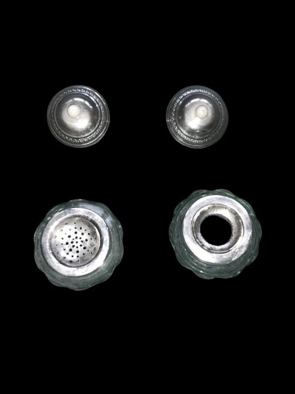 An inkwell made of embossed and openwork silver with stylized plant motifs and an enamel medallion.