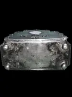 An inkwell made of embossed and openwork silver with stylized plant motifs and an enamel medallion.