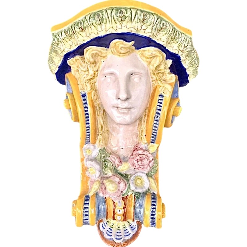 Majolica shelf featuring a neoclassical face and floral and geometric motifs in relief... Minardi