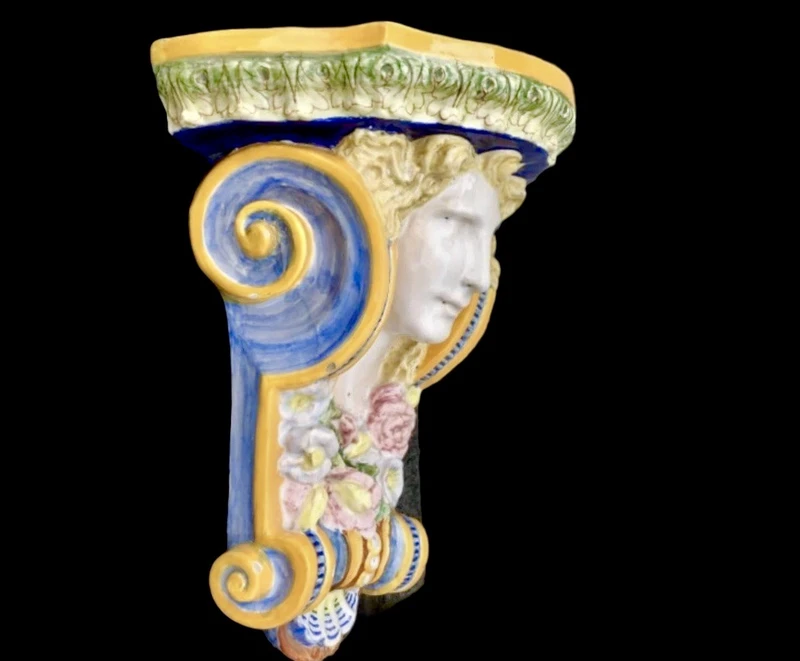 Majolica shelf featuring a neoclassical face and floral and geometric motifs in relief... Minardi
