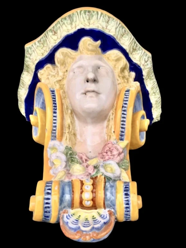 Majolica shelf featuring a neoclassical face and floral and geometric motifs in relief... Minardi