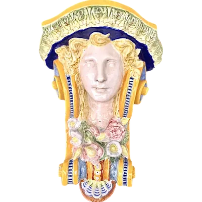Majolica shelf featuring a neoclassical face and floral and geometric motifs in relief... Minardi