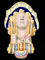 Majolica shelf featuring a neoclassical face and floral and geometric motifs in relief... Minardi