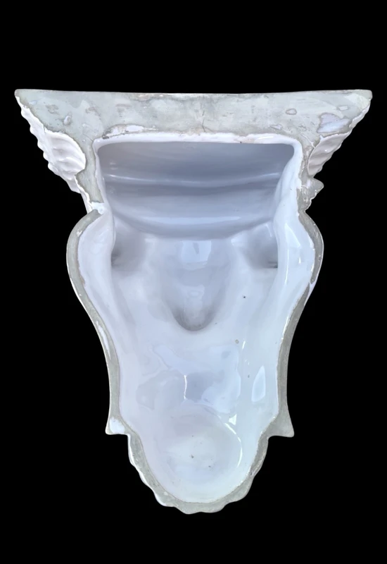 White majolica shelf featuring a female figure, dolphins, and geometric marine motifs. Faenza