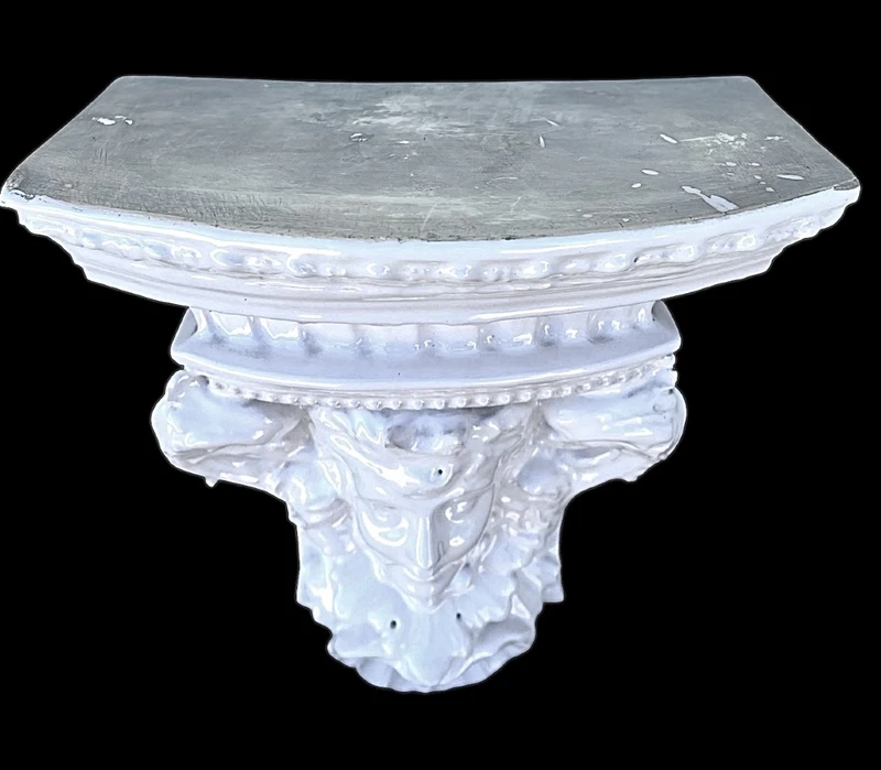 White majolica shelf featuring a female figure, dolphins, and geometric marine motifs. Faenza