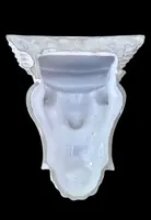 White majolica shelf featuring a female figure, dolphins, and geometric marine motifs. Faenza