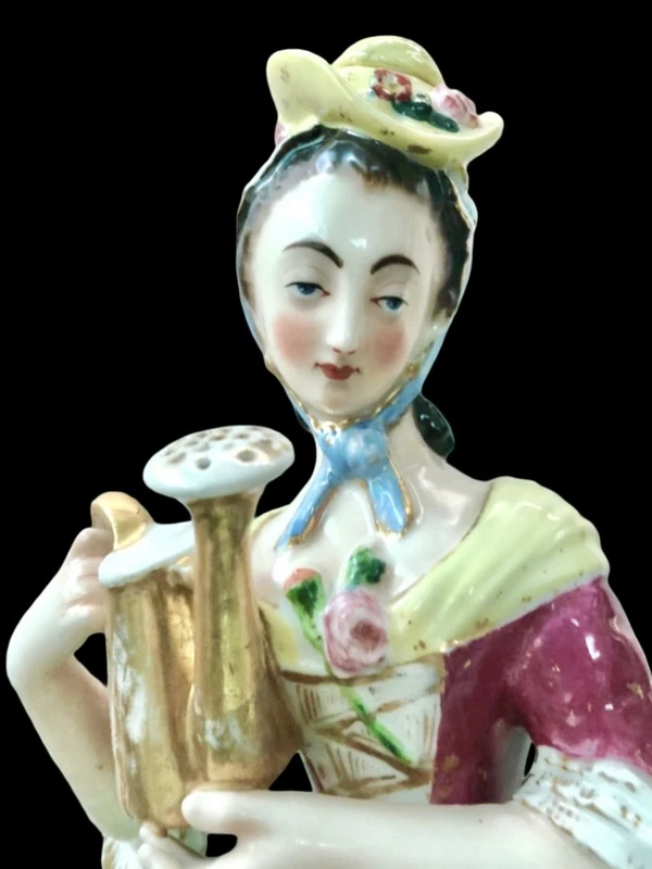 Polychrome porcelain tea pot nightlight depicting a lady with a watering can