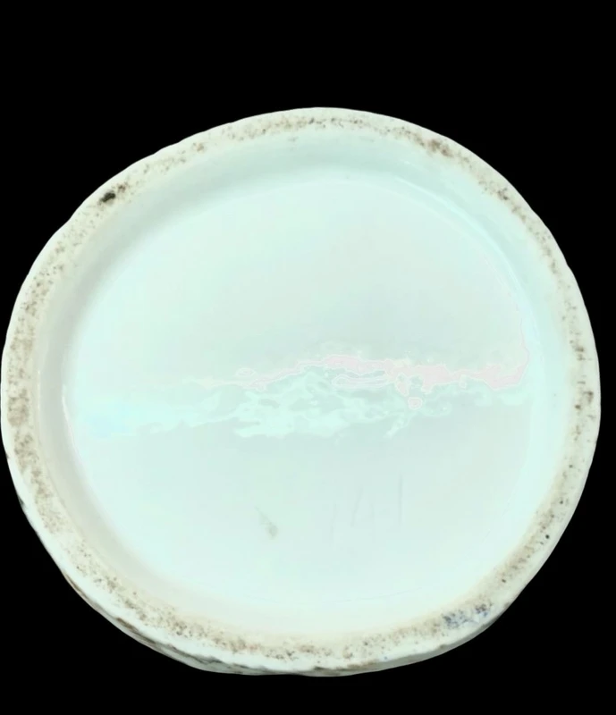 Polychrome porcelain tea pot nightlight depicting a lady with a watering can