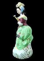 Polychrome porcelain tea pot nightlight depicting a lady with a watering can