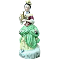 Polychrome porcelain tea pot nightlight depicting a lady with a watering can