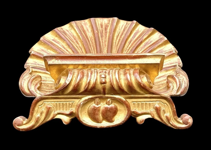 A shell-shaped lectern made of carved and gilded wood with rocaille motifs.