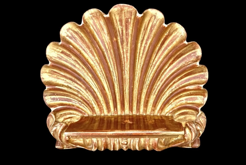 A shell-shaped lectern made of carved and gilded wood with rocaille motifs.