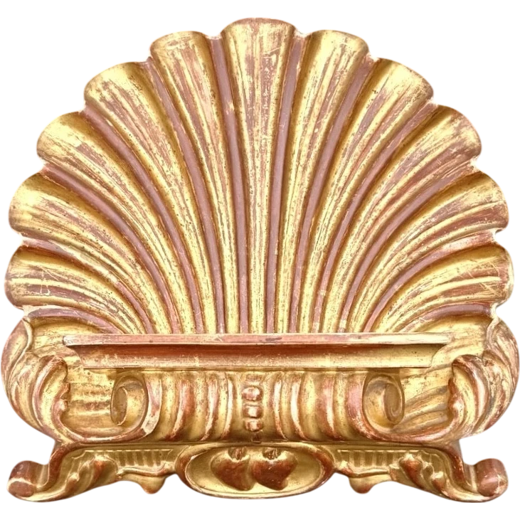 A shell-shaped lectern made of carved and gilded wood with rocaille motifs.