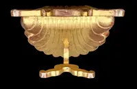A shell-shaped lectern made of carved and gilded wood with rocaille motifs.