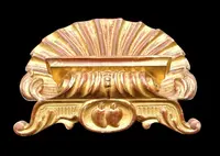 A shell-shaped lectern made of carved and gilded wood with rocaille motifs.