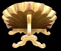 A shell-shaped lectern made of carved and gilded wood with rocaille motifs.