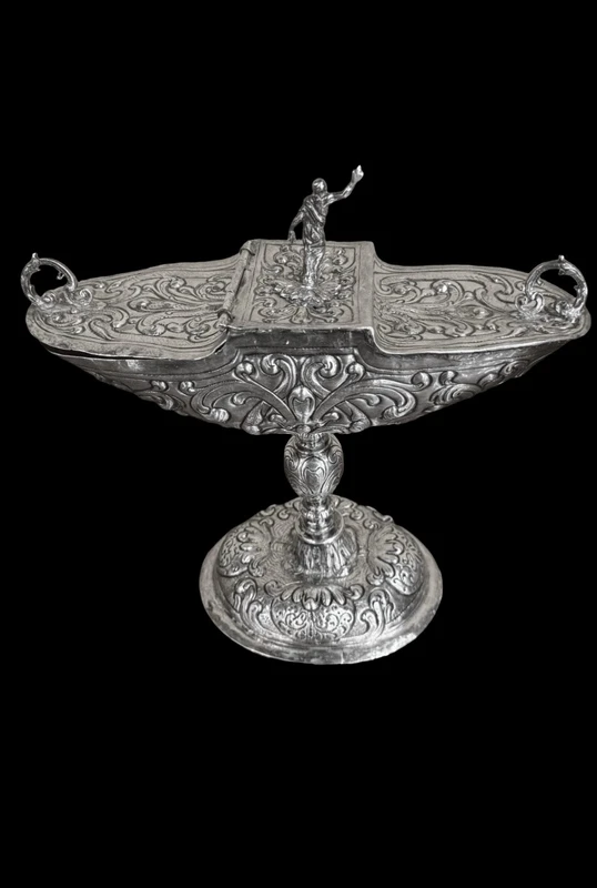 Cendrier en argent repoussé, orné de festons de feuilles et de volutes.