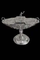 Cendrier en argent repoussé, orné de festons de feuilles et de volutes.