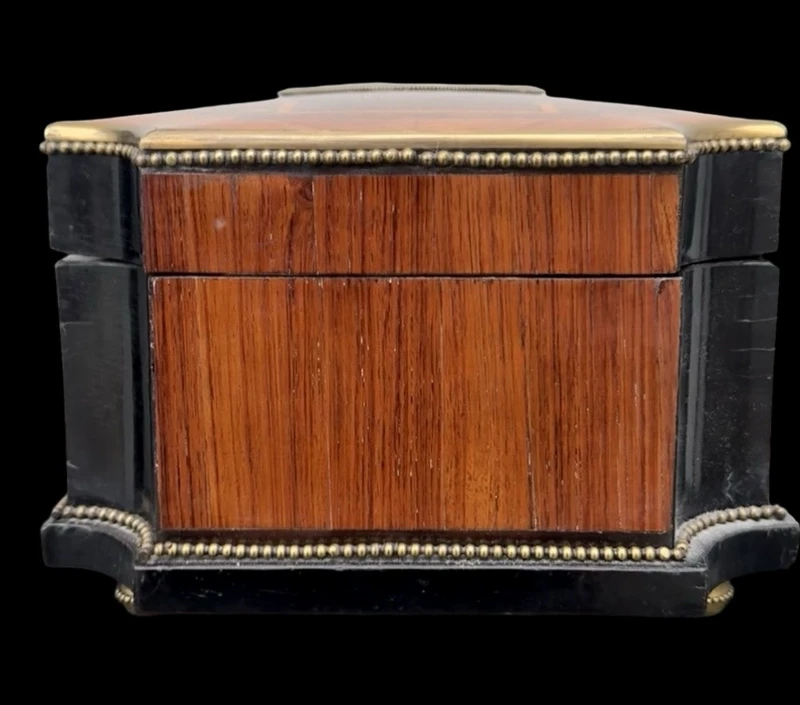 Wooden box inlaid with geometric patterns and a painted porcelain medallion