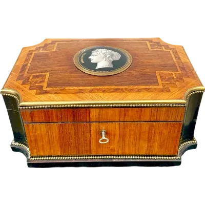 Wooden box inlaid with geometric patterns and a painted porcelain medallion
