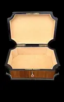 Wooden box inlaid with geometric patterns and a painted porcelain medallion