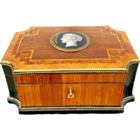 Wooden box inlaid with geometric patterns and a painted porcelain medallion