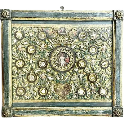 A reliquary frame featuring a relief composition of openwork wood with cherubs and plant motifs.