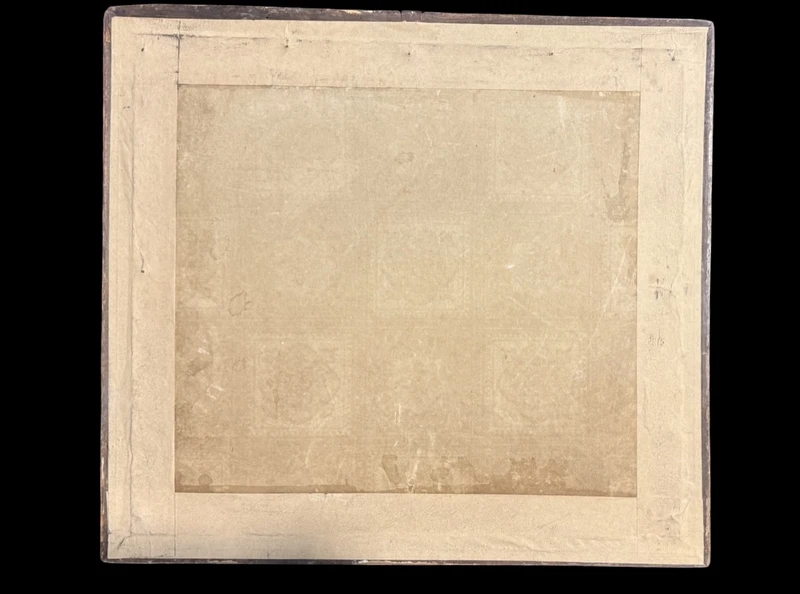 Framed panel featuring a vase of flowers embroidered on fabric.