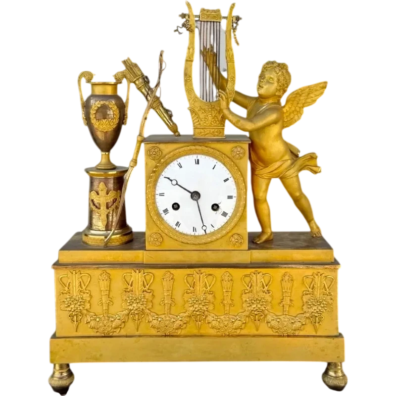 A clock made of mercury-gilded bronze depicting Cupid playing the lyre.