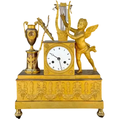 A clock made of mercury-gilded bronze depicting Cupid playing the lyre.