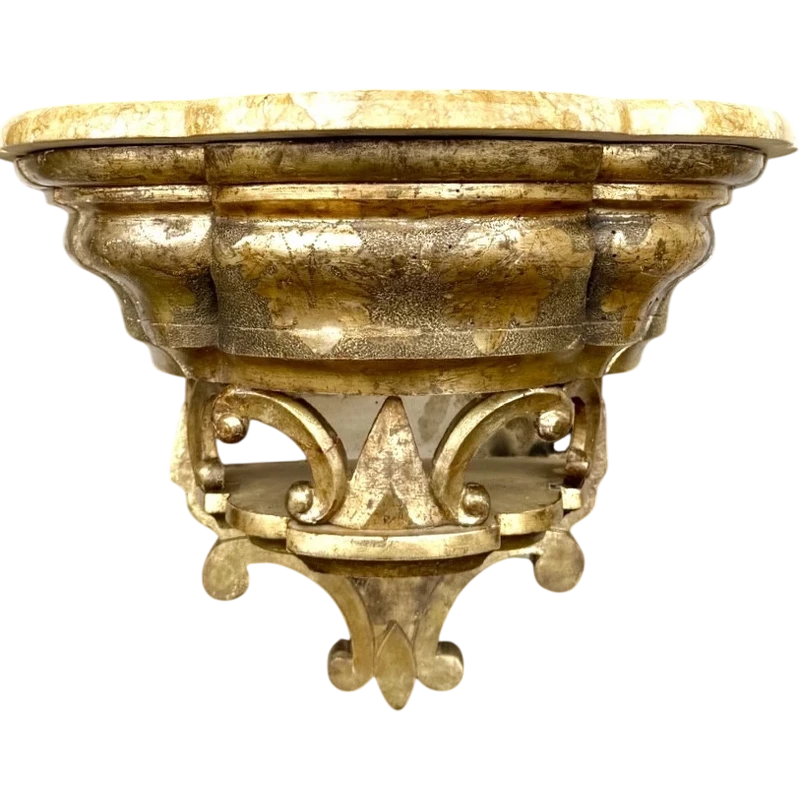 Carved wooden wall-mounted shelf with Mecca gilding and a marble top,