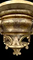 Carved wooden wall-mounted shelf with Mecca gilding and a marble top,