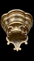 Carved wooden wall-mounted shelf with Mecca gilding and a marble top,