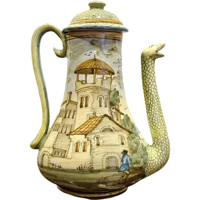 A majolica coffee pot with a pear-shaped body and a snake-shaped spout.
