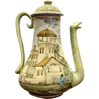 Cafetière en faïence, de forme piriforme, avec un bec verseur en forme de serpent.