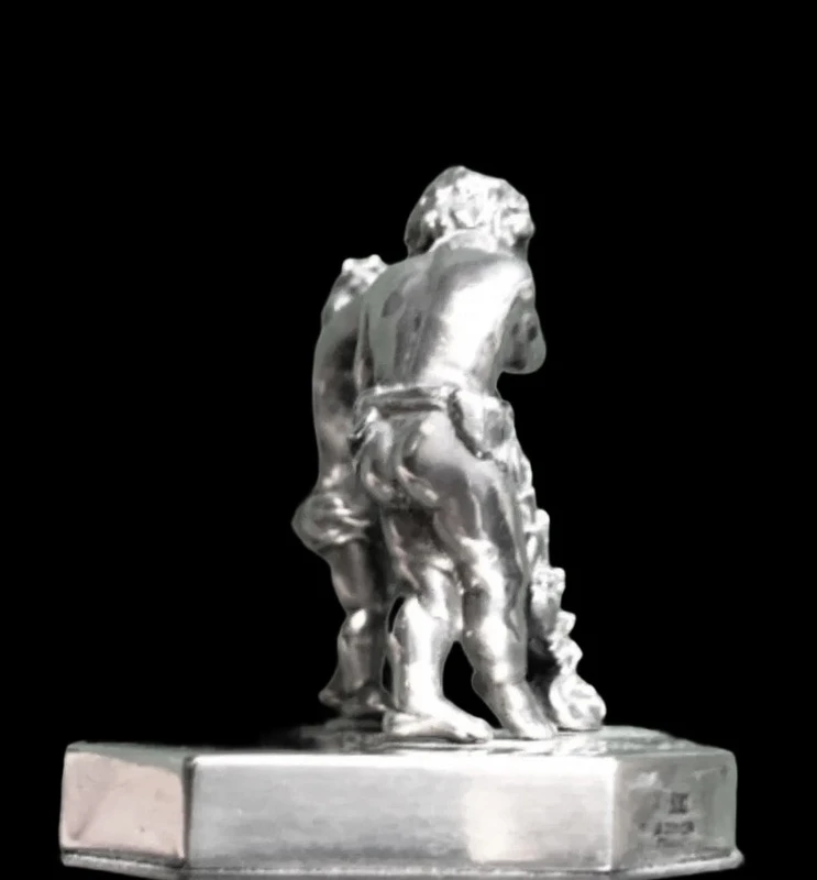 Solid silver paperweight featuring two cherubs holding up a portrait frame