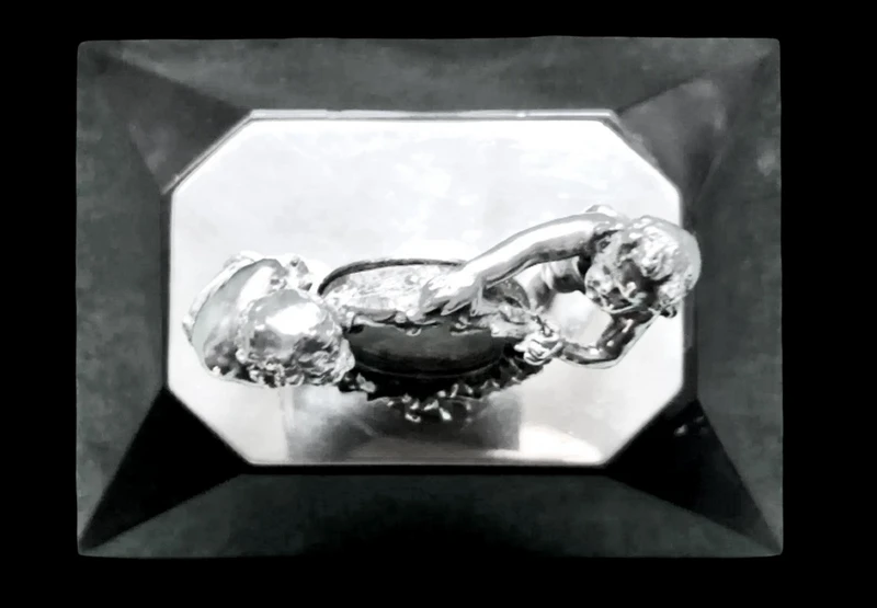 Solid silver paperweight featuring two cherubs holding up a portrait frame