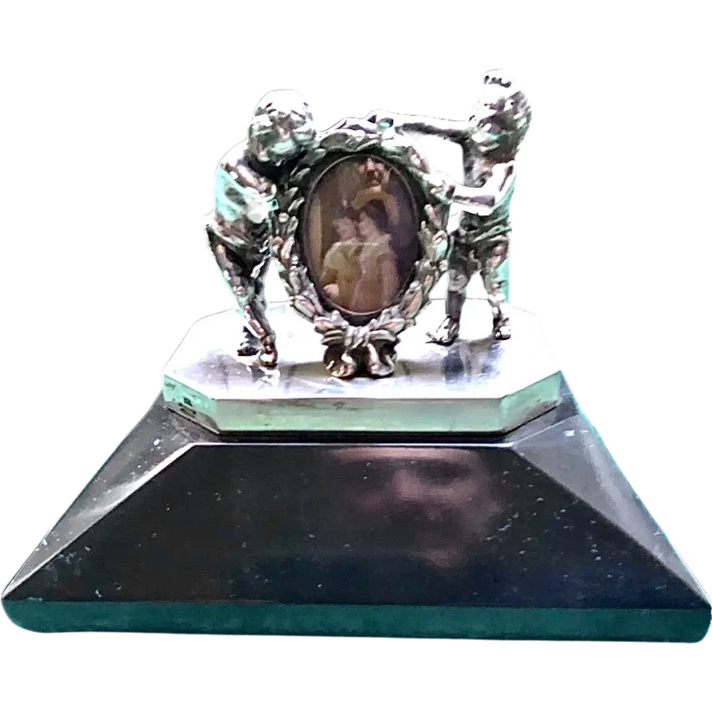 Solid silver paperweight featuring two cherubs holding up a portrait frame
