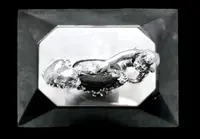Solid silver paperweight featuring two cherubs holding up a portrait frame