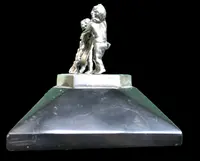 Solid silver paperweight featuring two cherubs holding up a portrait frame