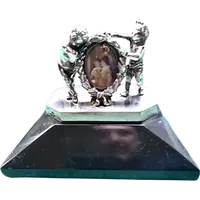 Solid silver paperweight featuring two cherubs holding up a portrait frame