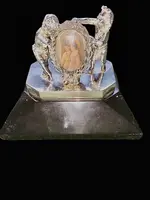 Solid silver paperweight featuring two cherubs holding up a portrait frame