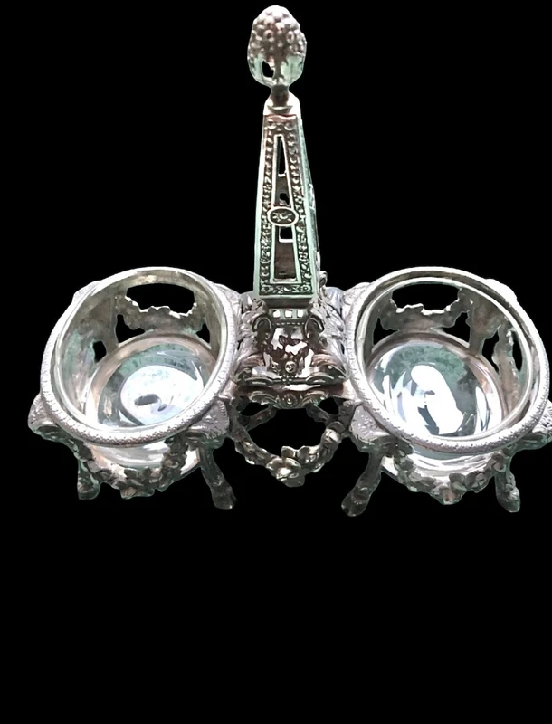 Double salt shaker set made of solid silver with glass compartments.