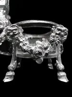 Double salt shaker set made of solid silver with glass compartments.