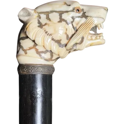A walking stick with an ivory knob shaped like a tiger's head.