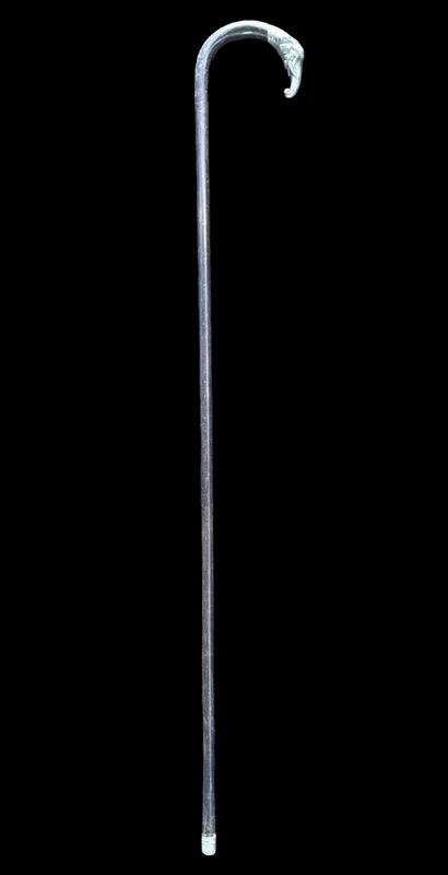 A walking stick with a silver knob shaped like an elephant's head.