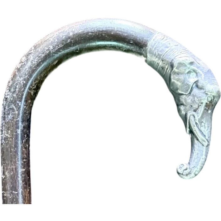 A walking stick with a silver knob shaped like an elephant's head.