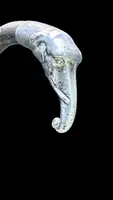 A walking stick with a silver knob shaped like an elephant's head.